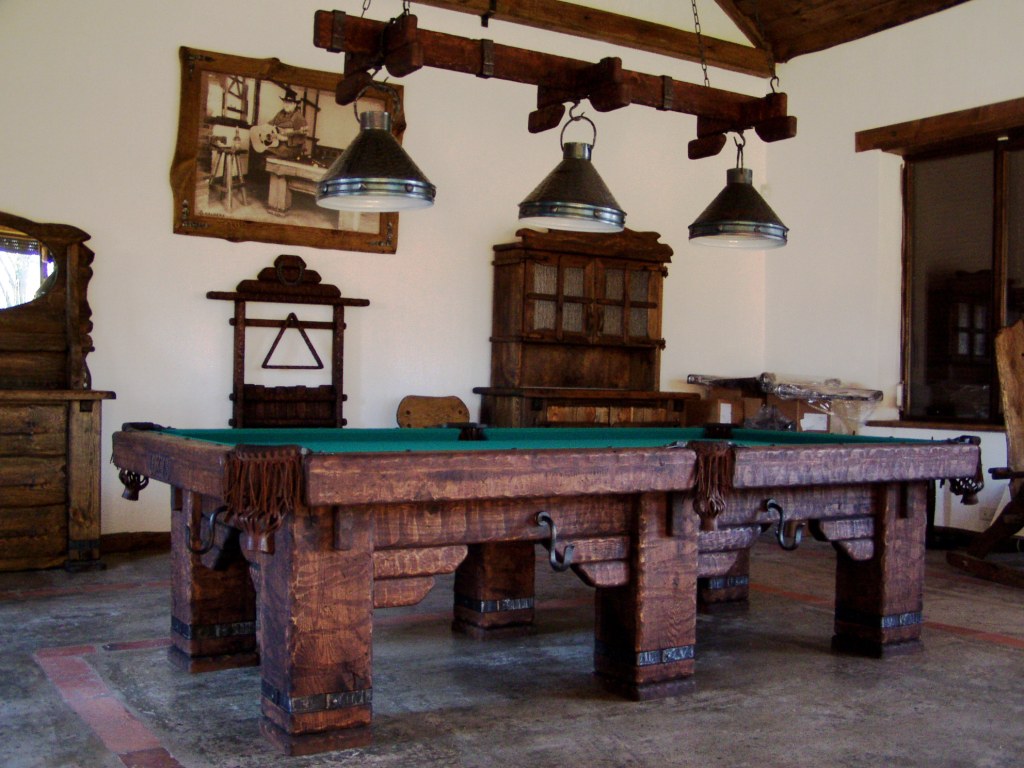 Wild West rustic log hand-made pool table by Vision Billiards showroom