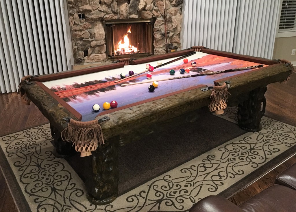 Wilderness rustic log pool table by Vision Billiards by fireplace